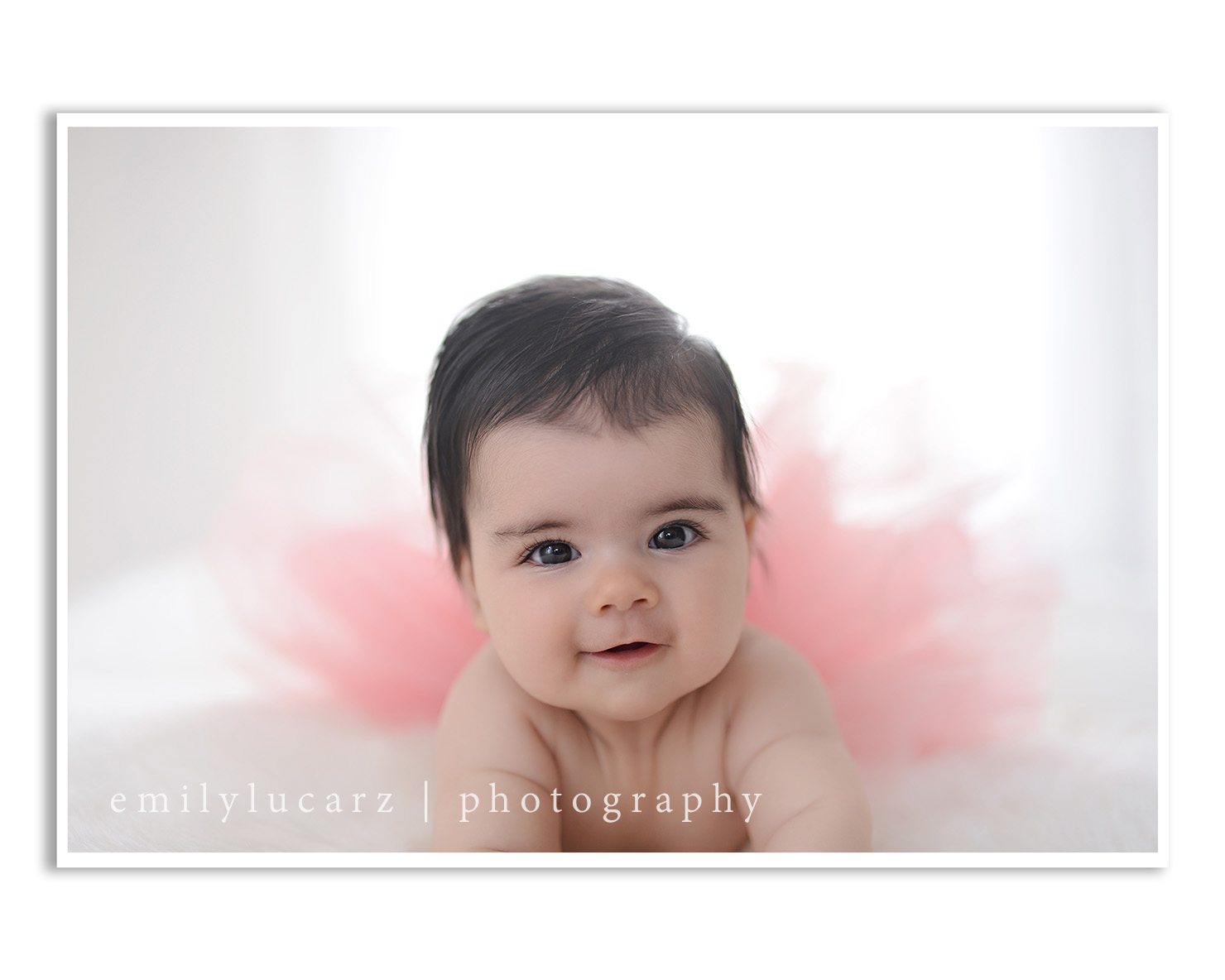 A darling 4 month old girl who had her photo taken in a yellow dress for a baby photography session in St. Louis MO