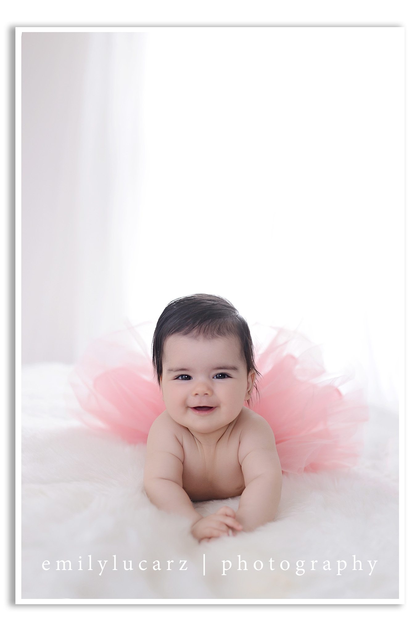 A darling 4 month old girl who had her photo taken in a yellow dress for a baby photography session in St. Louis MO